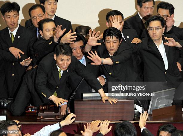 Security guards protect the speaker's podium in South Korea's parliament in Seoul on July 22, 2009 to help the ruling Grand National Party raidroad...