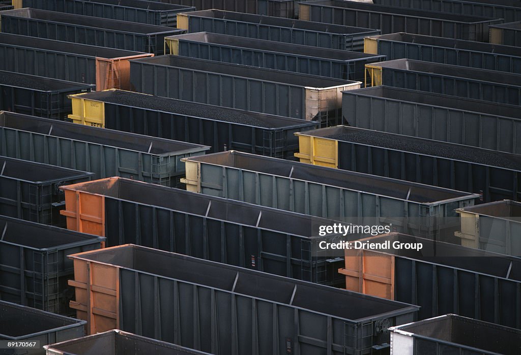 Open hopper cars in a train yard.