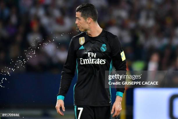 Real Madrid's Portuguese forward Cristiano Ronaldo spits water during the FIFA Club World Cup semi-final match in the Emirati capital Abu Dhabi on...