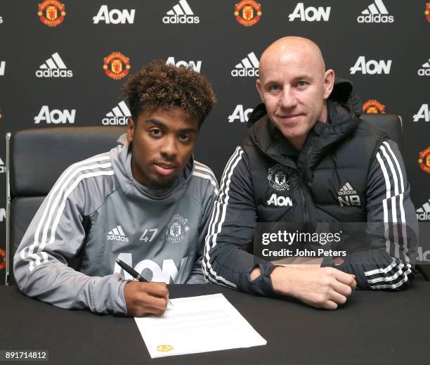 Angel Gomes of Manchester United signs his first professional contract with the club at Aon Training Complex on December 13, 2017 in Manchester,...