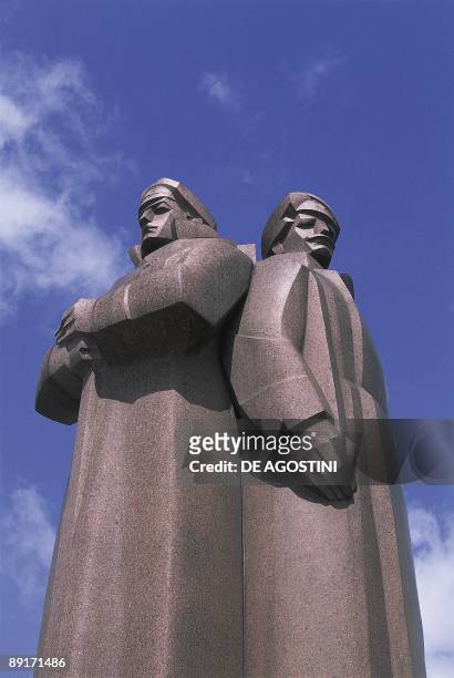 Low angle view of two statues, Red Latvian Riflemen, Riga, Latvia