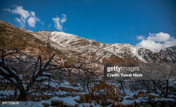 View of snow clad mountains after seasons first snowfall on December 13, 2017 In the outskirts of Srinagar, the summer capital of Indian administered...