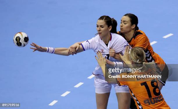 Netherlands' Yvette Broch and Kelly Dulfer vie with Czech Republic's Iveta Luzumova during the IHF Womens World Championship handball quarter final...