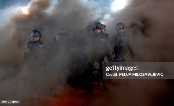 Policemen are engulfed in smoke after two groups of Partizan Belgrade's hooligans clashed with each other during the Serbian Superleague derby...