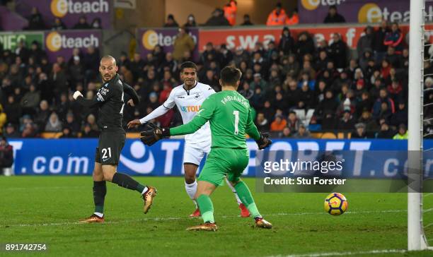 David Silva of Manchester City scores his sides first goal past Lukasz Fabianski of Swansea City during the Premier League match between Swansea City...