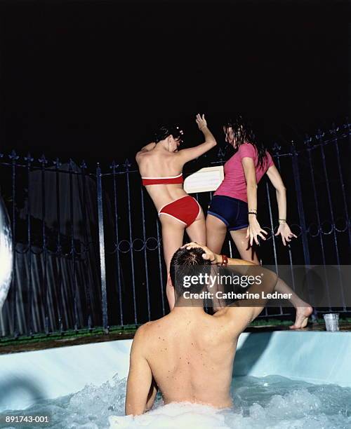 man in hot tub watching two women dancing - hot tub party stock pictures, royalty-free photos & images