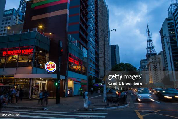 Pedestrians pass in front of a Burger King do Brasil restaurant on Paulista Avenue in Sao Paulo, Brazil, on Monday, Dec. 11, 2017. Burger King do...