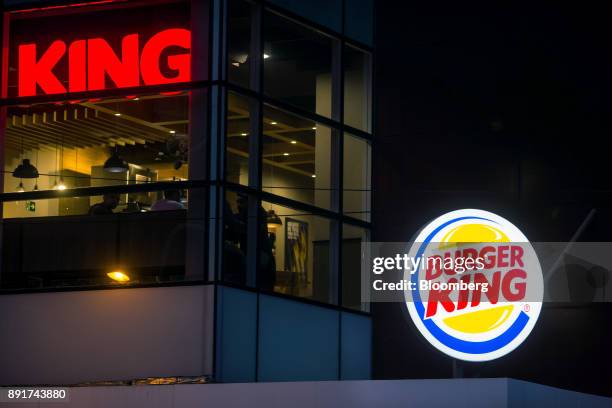 Signage is seen illuminated at night outside of a Burger King do Brasil restaurant on Paulista Avenue in Sao Paulo, Brazil, on Monday, Dec. 11, 2017....