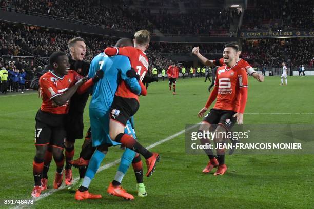 Rennes' French goalkeeper Abdoulaye Diallo is congratulated by his teammates after winning the French League Cup round of 16 football match between...