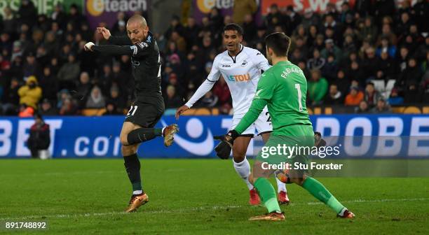 Manchester City player David Silva scores the opening goal past Lukasz Fabianski during the Premier League match between Swansea City and Manchester...