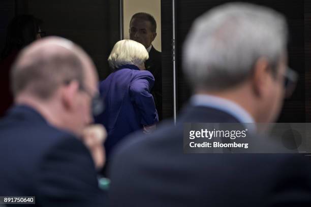 Janet Yellen, chair of the U.S. Federal Reserve, center, exits after a news conference following a Federal Open Market Committee meeting in...