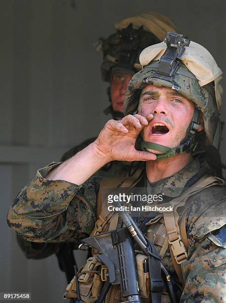 Marine from the 31st Marine Expenditionary Unit yells instructions to his troops during the combined urban combat training exercise as part of...