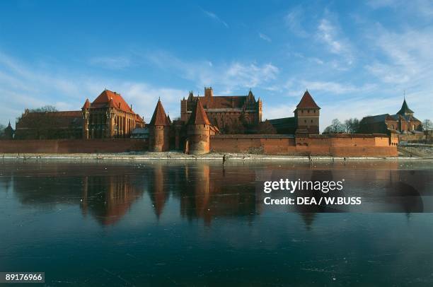 Reflection of a castle on the river, Nogat River, Malbork Castle, Malbork, Pomorskie Province, Poland