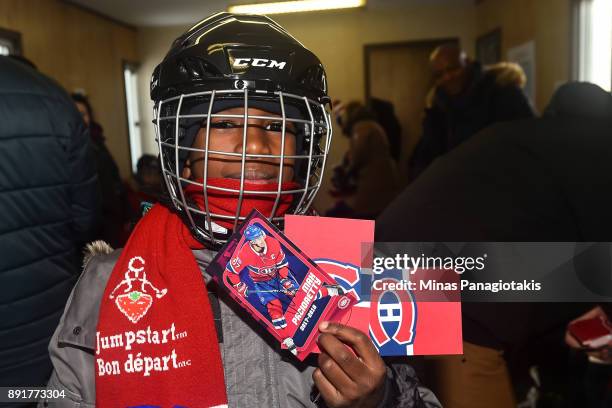 Youngster shows off his autographed cards during the official inauguration of the Bleu Blanc Bouge rink by the Montreal Canadiens, NHL and NHLPA at...