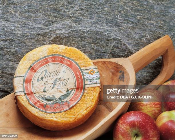 Close-up of cheese in a wooden scoop