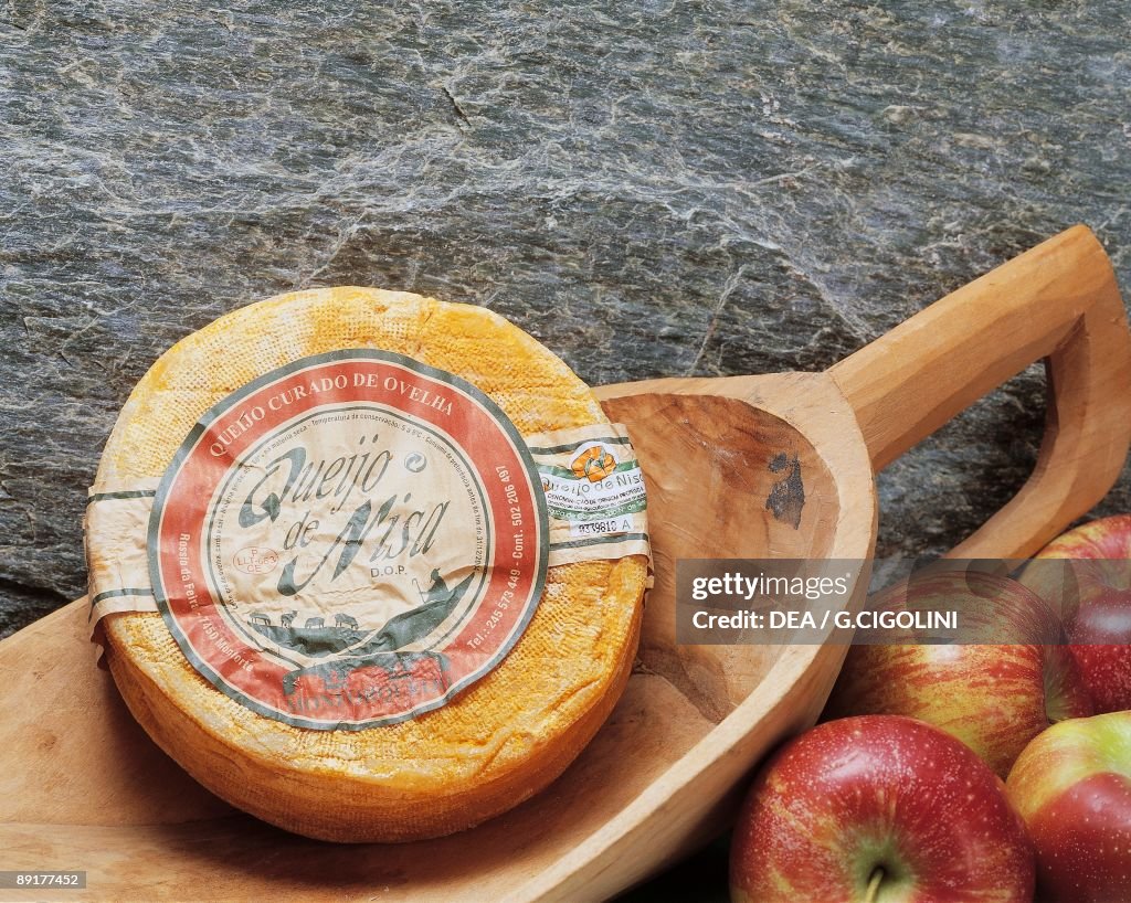 Close-up of cheese in a wooden scoop (Queijo de Nisa)
