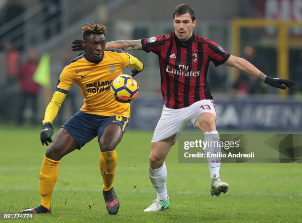 Moise Kean of Hellas Verona competes for the ball with Alessio Romagnoli of AC Milan during the Tim Cup match between AC Milan and Hellas Verona FC...