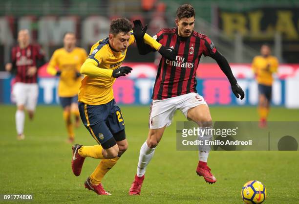 Andre Silva of AC Milan competes for the ball with Alex Ferrari of Hellas Verona during the Tim Cup match between AC Milan and Hellas Verona FC at...