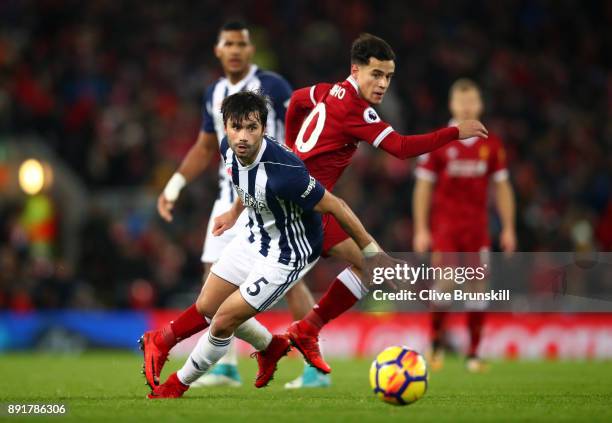 Claudio Yacob of West Bromwich Albion attempts to get away from Philippe Coutinho of Liverpool during the Premier League match between Liverpool and...