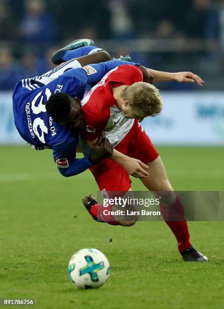 Breel Embolo of Schalke and Martin Hinteregger of Augsburg battle for the ball during the Bundesliga match between FC Schalke 04 and FC Augsburg at...