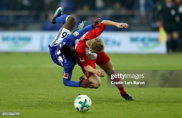 Breel Embolo of Schalke and Martin Hinteregger of Augsburg battle for the ball during the Bundesliga match between FC Schalke 04 and FC Augsburg at...