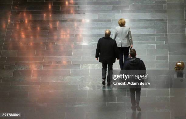 German Chancellor Angela Merkel leaves a meeting in the Bundestag with leaders of the SPD, CSU and her own party on December 13, 2017 in Berlin,...