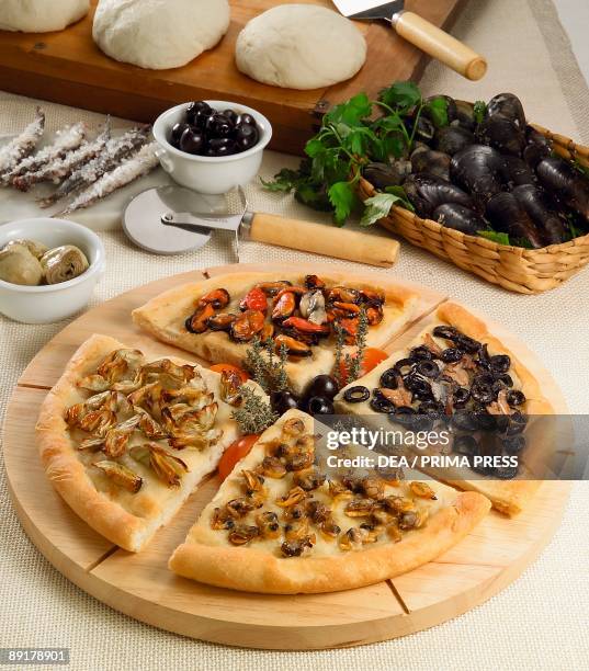 Close-up of pizza Quattro stagioni on a cutting board