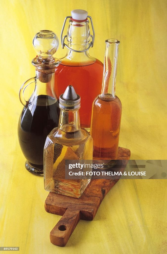 Close-up of four bottles of vinegar