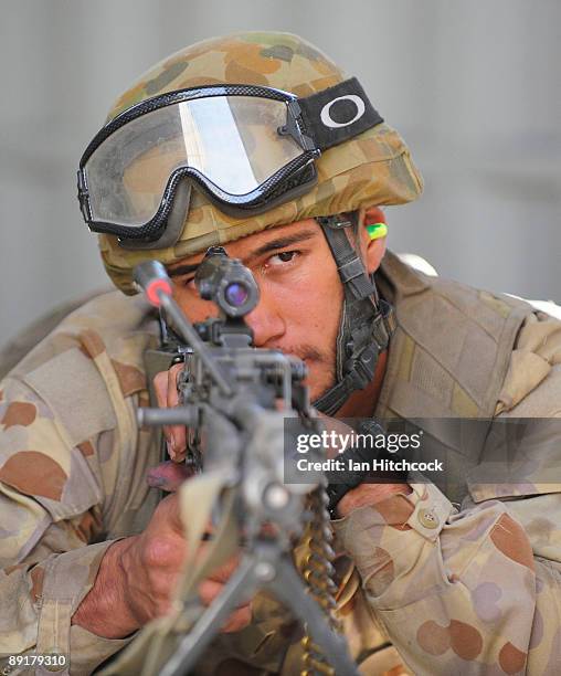 An Australian soldier who is role playing as an enemy soldier is ready with his machine gun for an attack by U.S Marines from the 31st Marine...