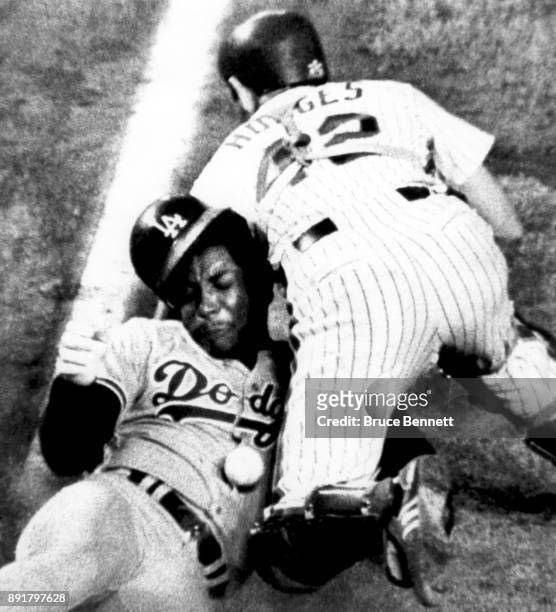 Dusty Baker of the Los Angeles Dodgers crashes into catcher Ron Hodges of the New York Mets to knock the ball loose as he scores during an MLB game...