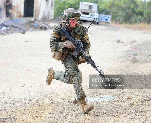 Marine from the 31st Marine Expenditionary Unit runs for cover during the combined urban combat training exercise as part of Exercise Talisman Saber...