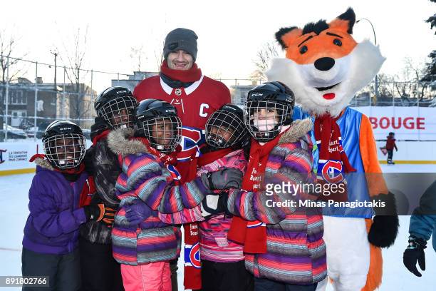 Max Pacioretty of the Montreal Canadiens poses with a group of children during the official inauguration of the Bleu Blanc Bouge rink by the Montreal...