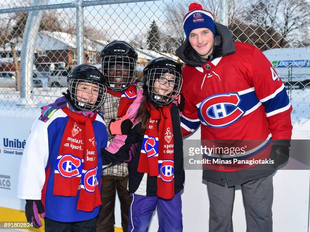 Daniel Carr of the Montreal Canadiens poses with a few children during the official inauguration of the Bleu Blanc Bouge rink by the Montreal...