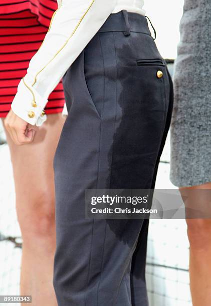 Actress Sienna Miller poses for a photograph with wet trousers on HMS Belfast after arriving on a Royal Marine RIB during a photocall to launch 'G.I...