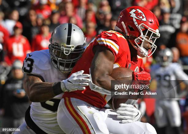 Middle linebacker NaVorro Bowman of the Oakland Raiders tackles running back Kareem Hunt of the Kansas City Chiefs during the first half at Arrowhead...