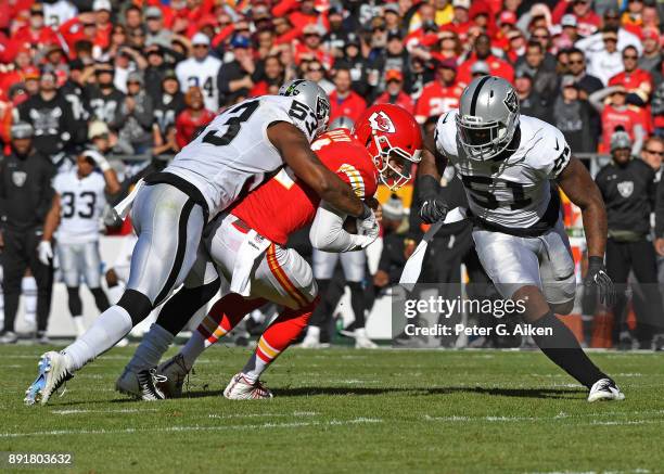 Middle linebacker NaVorro Bowman of the Oakland Raiders tackles quarterback Alex Smith of the Kansas City Chiefs during the first half at Arrowhead...