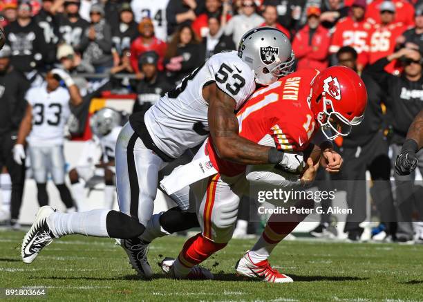 Middle linebacker NaVorro Bowman of the Oakland Raiders tackles quarterback Alex Smith of the Kansas City Chiefs during the first half at Arrowhead...