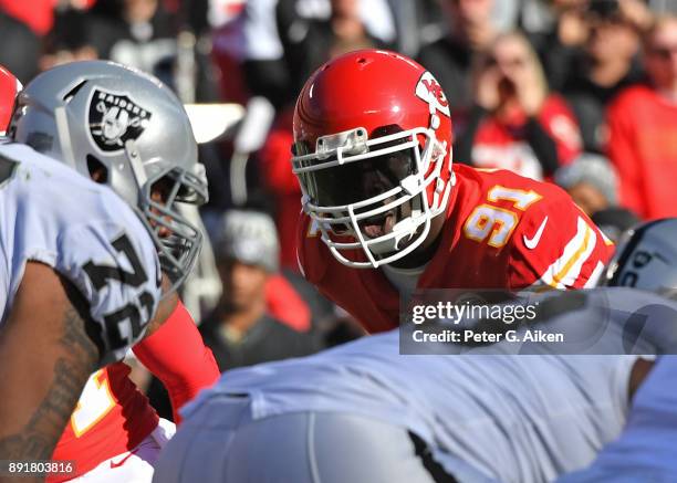 Outside linebacker Tamba Hali of the Kansas City Chiefs looks across the line against the Oakland Raiders during the first half at Arrowhead Stadium...