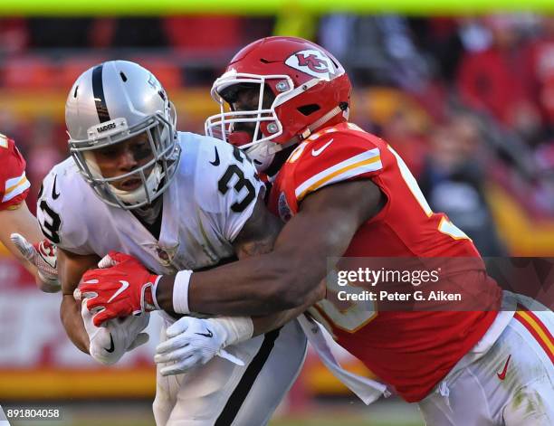 Outside linebacker Justin Houston of the Kansas City Chiefs tackles running back DeAndre Washington of the Oakland Raiders during the second half at...