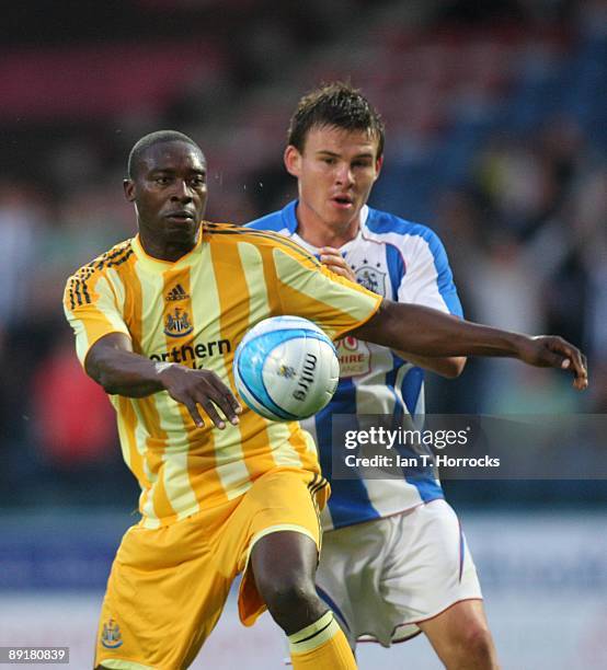 Shola Ameobi in action during a pre-season friendly match between Huddersfield Town and Newcastle United at the Galpharm Stadium on July 21, 2009 in...