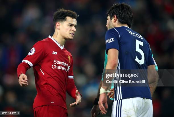 Philippe Coutinho of Liverpool argues with Claudio Yacob of West Bromwich Albion during the Premier League match between Liverpool and West Bromwich...