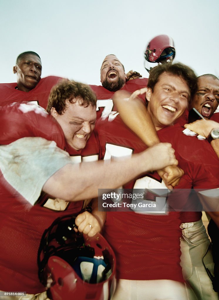 Football players celebrating on sideline