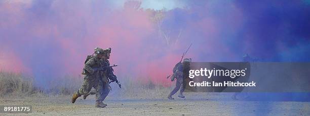 Marines from the 31st Marine Expenditionary Unit go on the attack during the combined urban combat training exercise as part of Exercise Talisman...