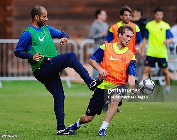 Barcelona manager Josep Guardiola is challenged by Alexander Hleb during an FC Barcelona training session at Bisham Abbey on July 22, 2009 in Marlow,...