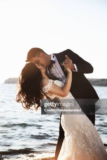 bride and groom, enjoying amazing sunset - beach wedding stock pictures, royalty-free photos & images
