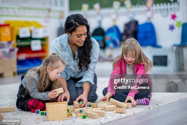 girls playing with teacher - inclusive classroom stock pictures, royalty-free photos & images