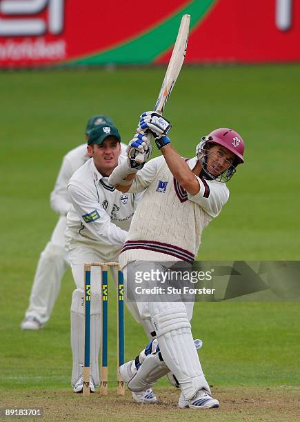 Somerset batsman Justin Langer hits a six watched by Worcestershire wicketkeeper Steven Davies during his half century during day two of the LV...