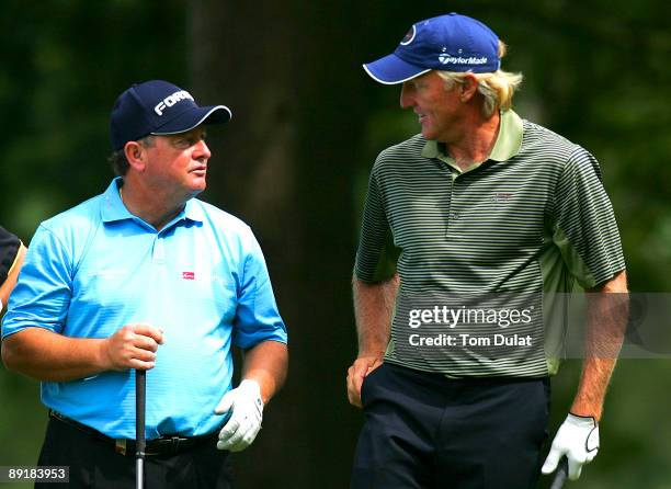 Ian Woosnam and Greg Norman talk during previews of the Senior Open Championship at the Sunningdale Golf Club on July 22, 2009 in Sunningdale,...