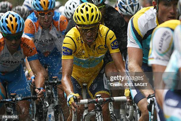 Yellow jersey of overall leader, 2007 Tour de France winner and Kazakh cycling team Astana 's leader Alberto Contador of Spain , rides under the rain...