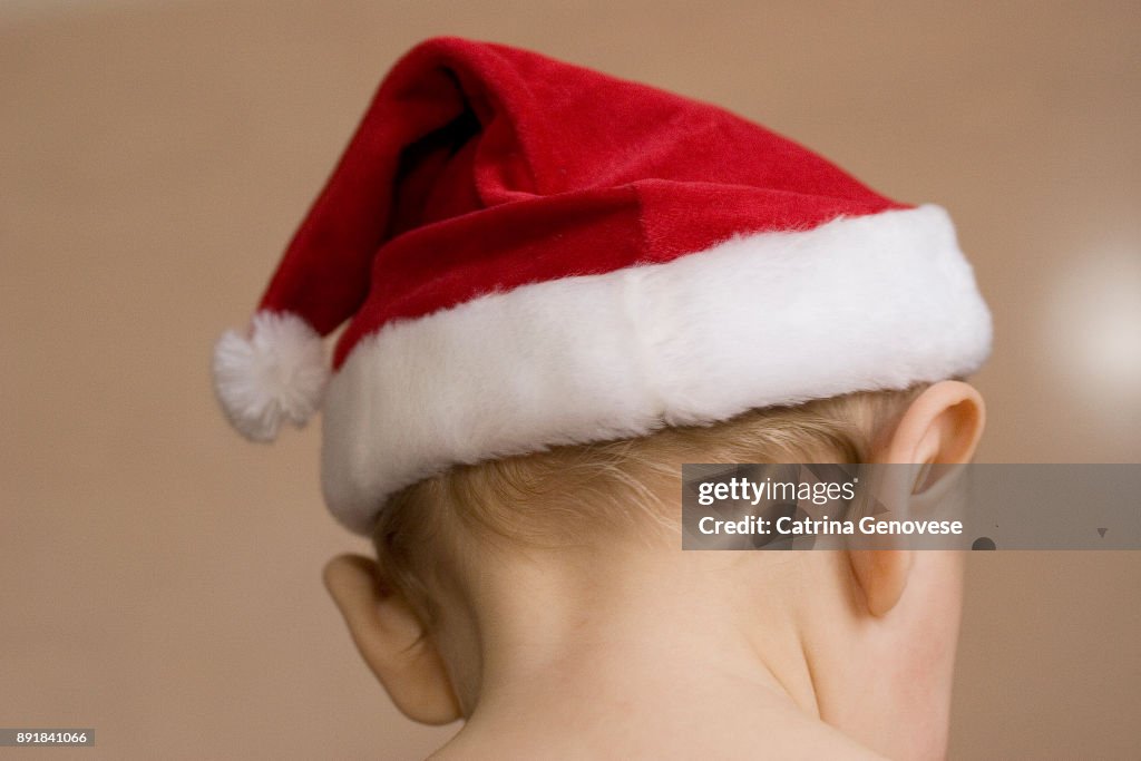 9 month old boy dressed in Santa Claus costume on Christmas